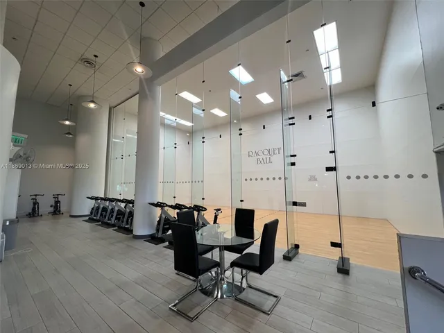 a view of a dining room with furniture large windows and wooden floor