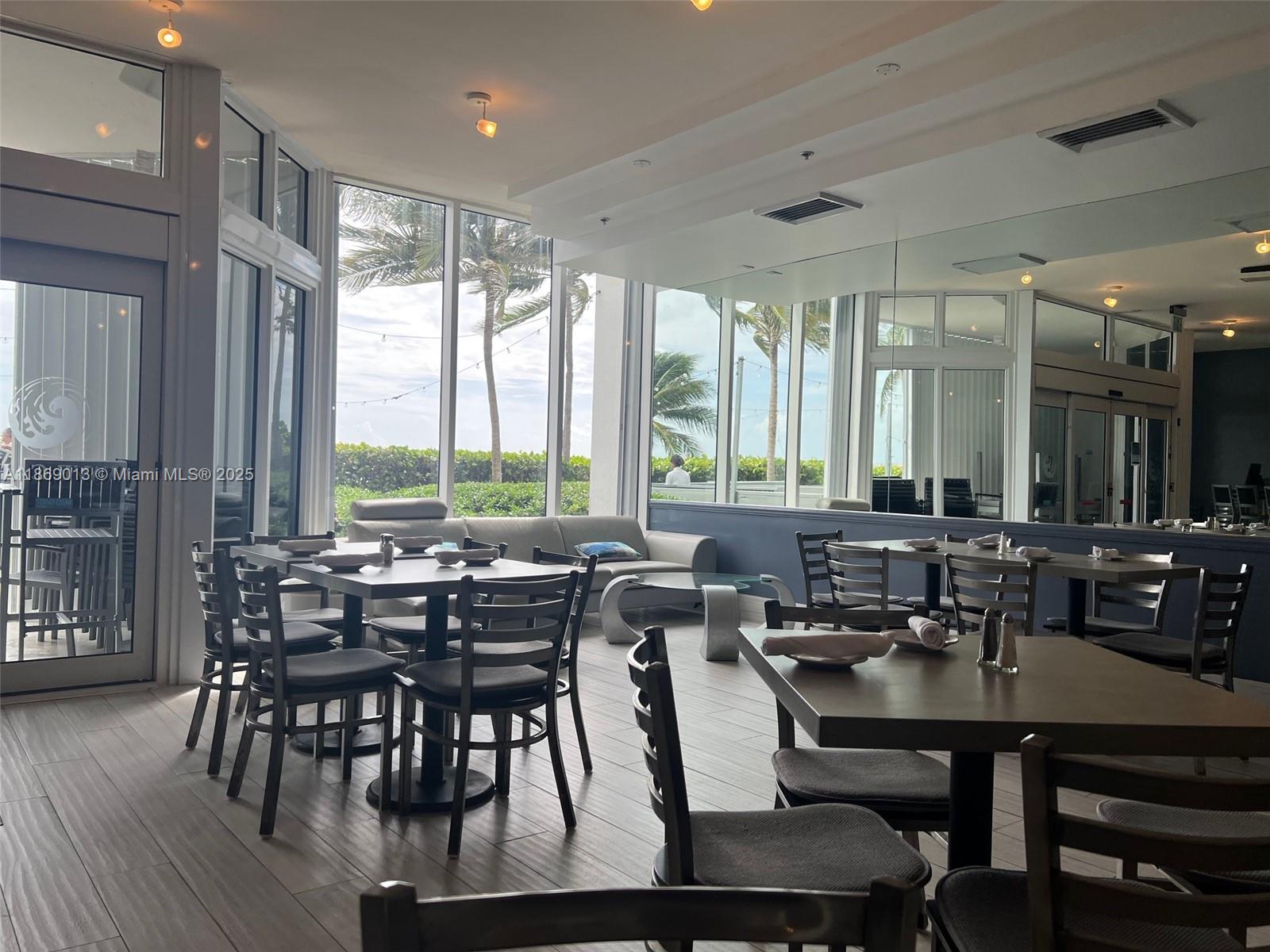 16500 Collins Avenue, Unit 655 Sunny Isles Beach, FL 33160 - Photo 46 of 48 a view of a dining room with furniture window and wooden floor