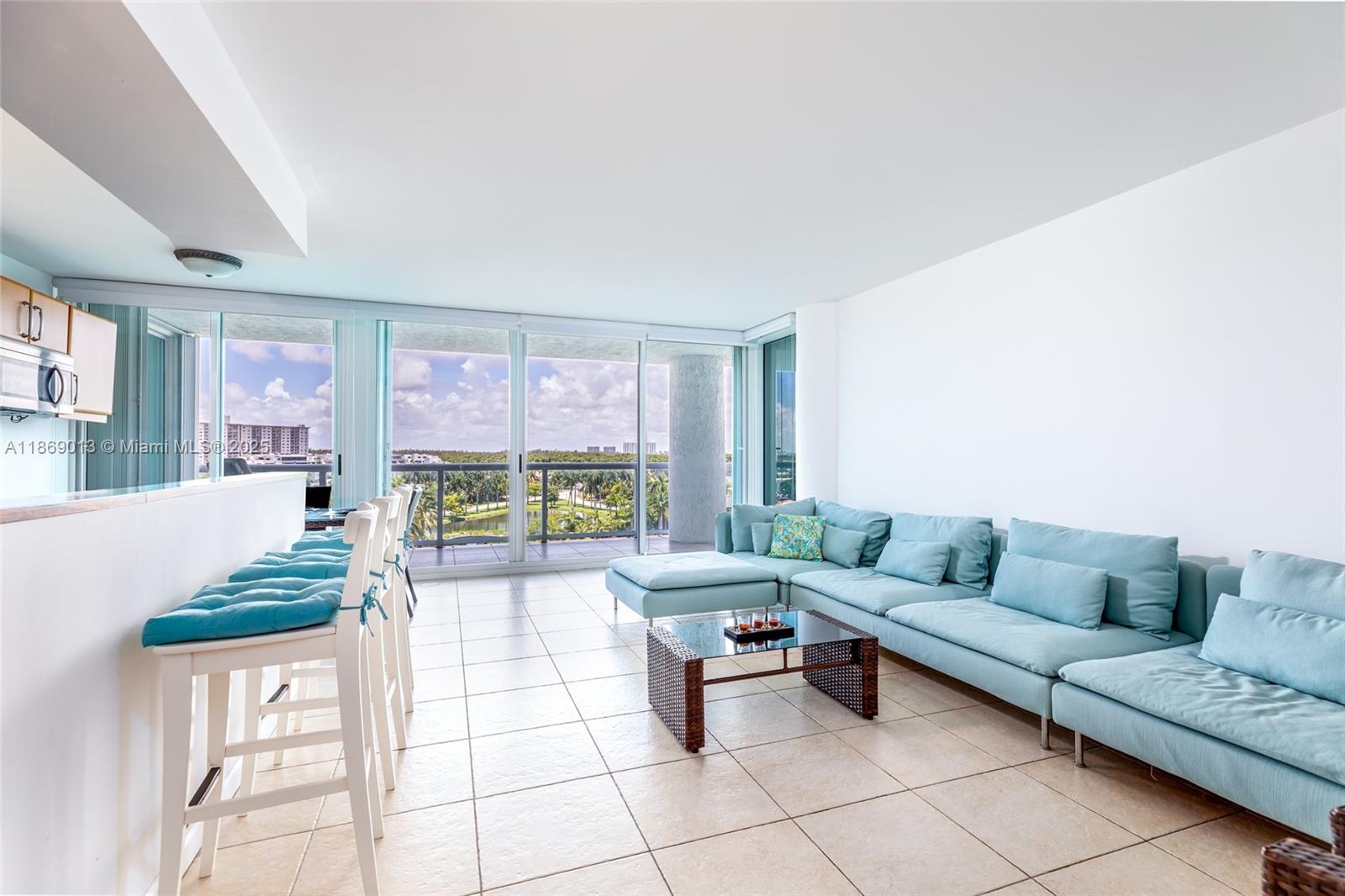 16500 Collins Avenue, Unit 655 Sunny Isles Beach, FL 33160 - Photo 9 of 48 a living room with furniture and a floor to ceiling window