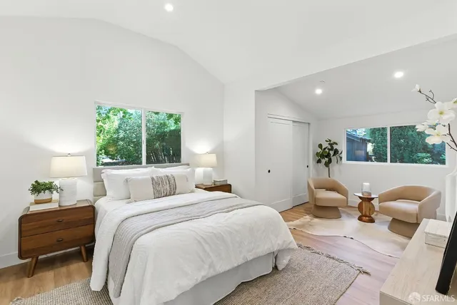 a bedroom with a bed and a large window