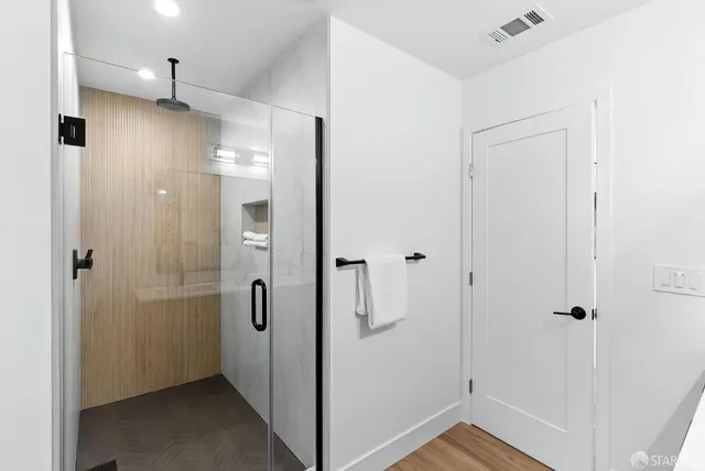 a bathroom with a shower and a sink