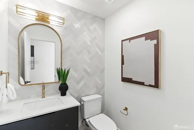 a bathroom with a toilet sink and mirror