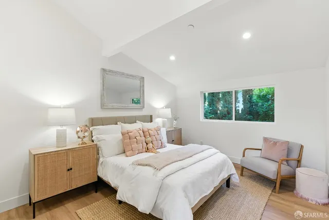 a bedroom with a large bed and a window