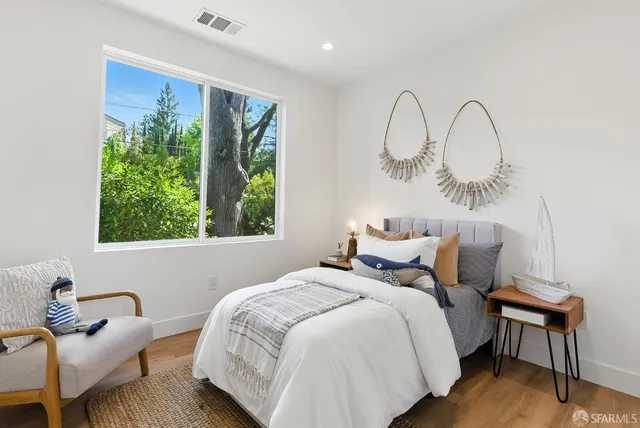 a bedroom with a bed and a chair