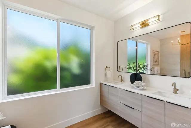 a bathroom with a double vanity sink and mirror