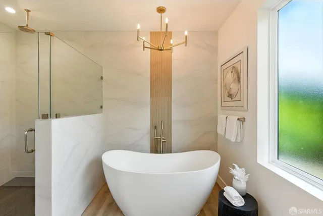 a bathroom with a white tub shower