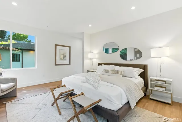 a bedroom with a bed a table and chair