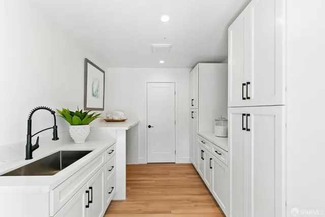 a kitchen with stainless steel appliances a sink and cabinets