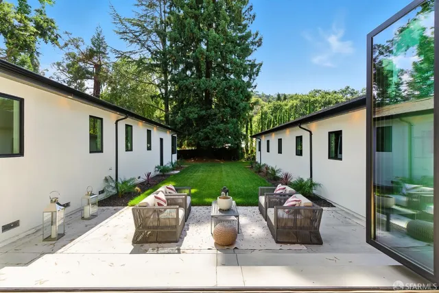a view of a house with backyard sitting area and garden
