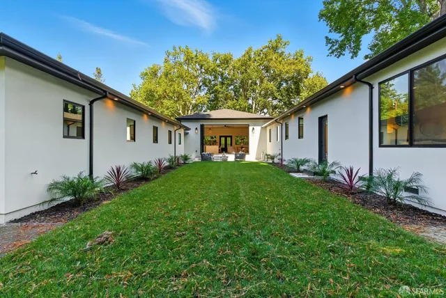 a front view of house with a garden