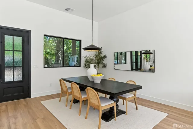 a dining room with furniture and window