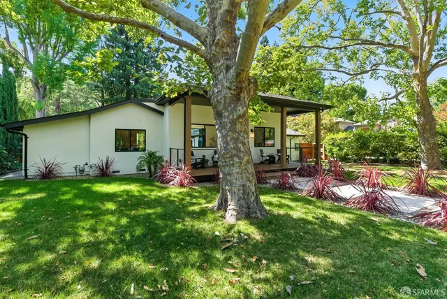 a front view of house with yard and outdoor seating