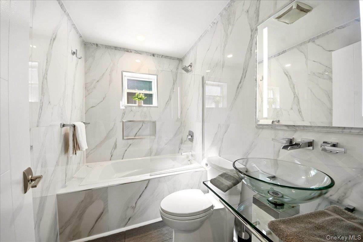 93 Fordham Street Bronx, NY 10464 - Photo 16 of 41 a bathroom with a sink toilet and shower