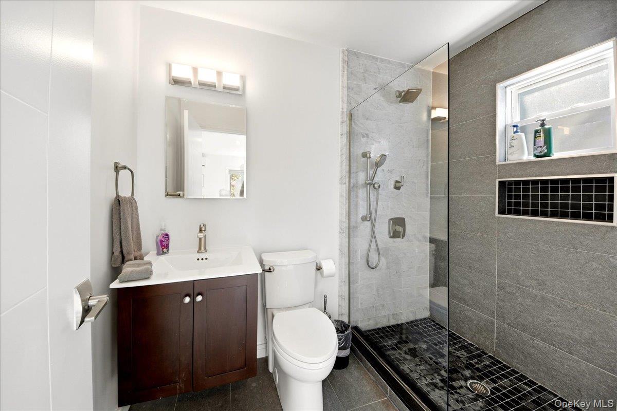 93 Fordham Street Bronx, NY 10464 - Photo 19 of 41 a bathroom with a sink toilet and shower