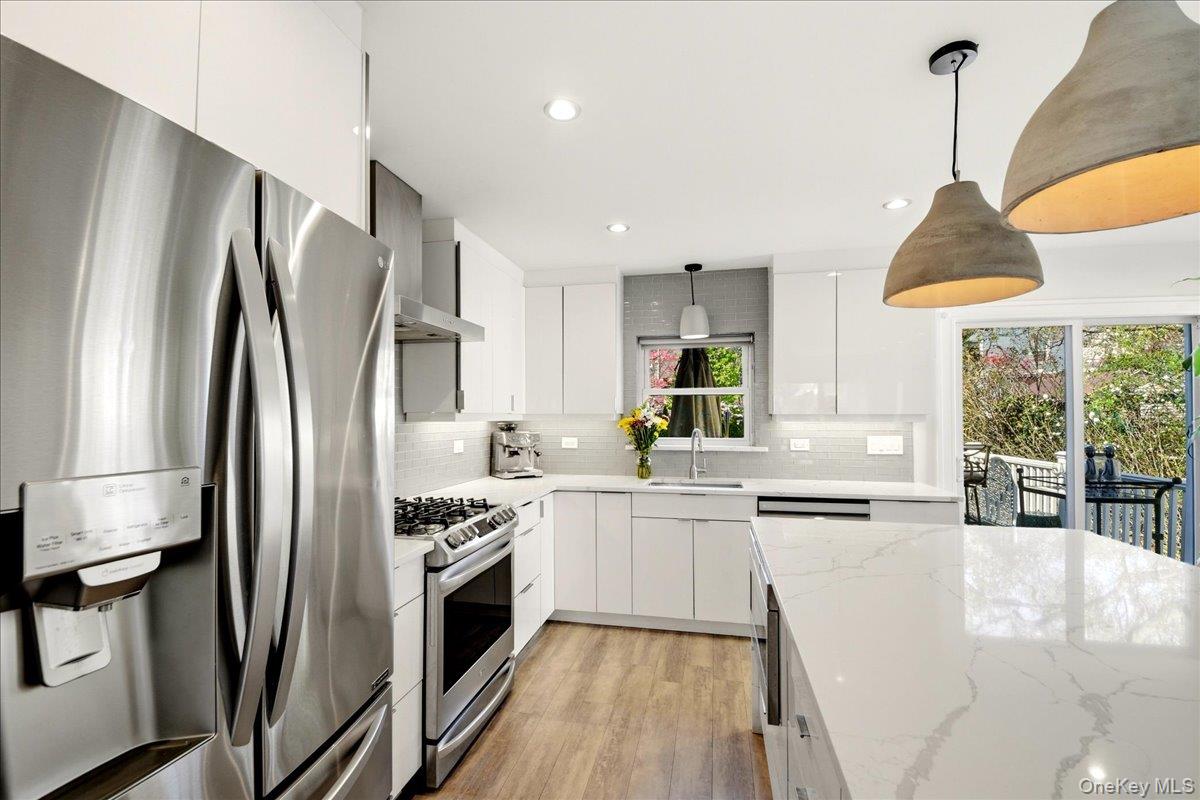 93 Fordham Street Bronx, NY 10464 - Photo 24 of 41 a kitchen with stainless steel appliances a refrigerator sink and cabinets