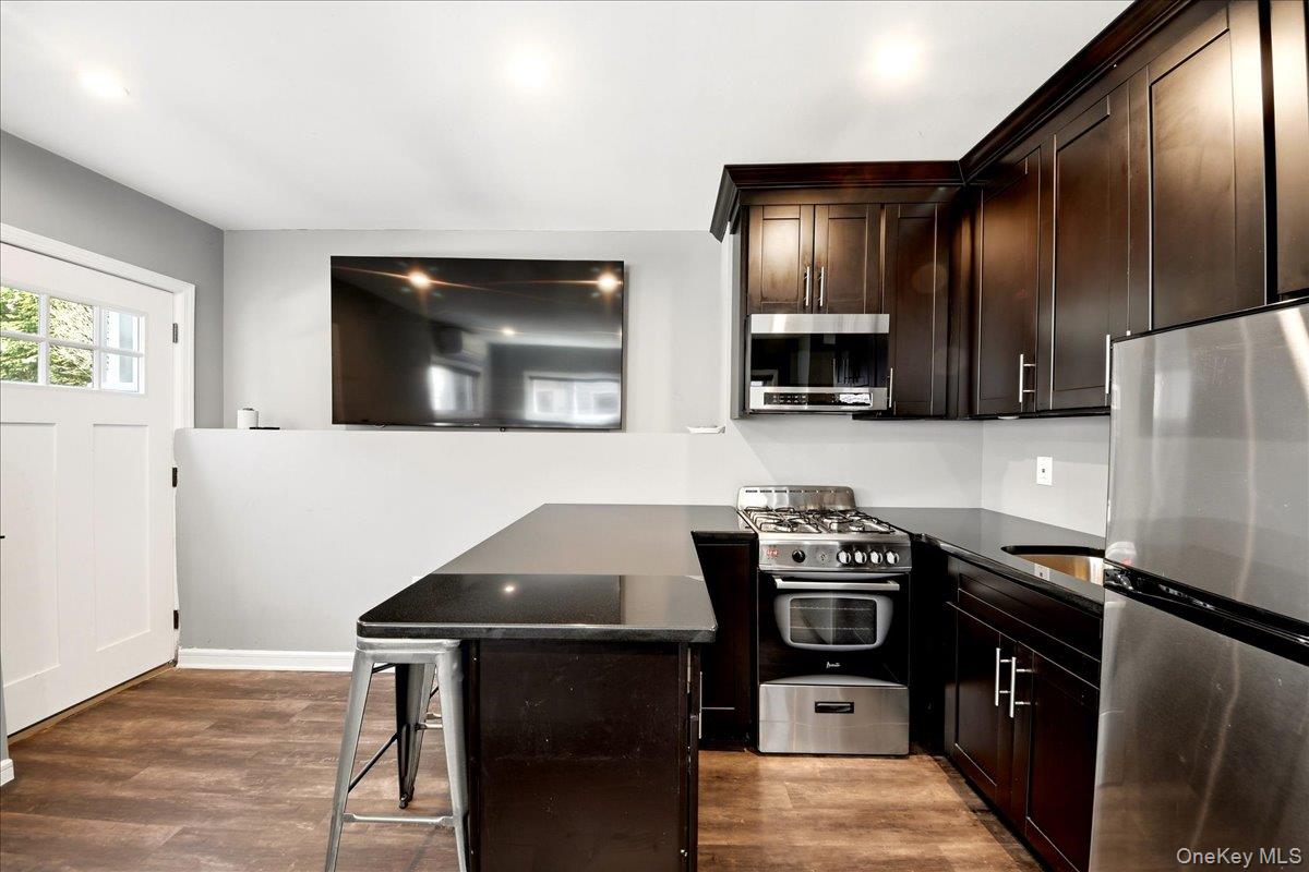 93 Fordham Street Bronx, NY 10464 - Photo 30 of 41 a kitchen with a stove and a microwave