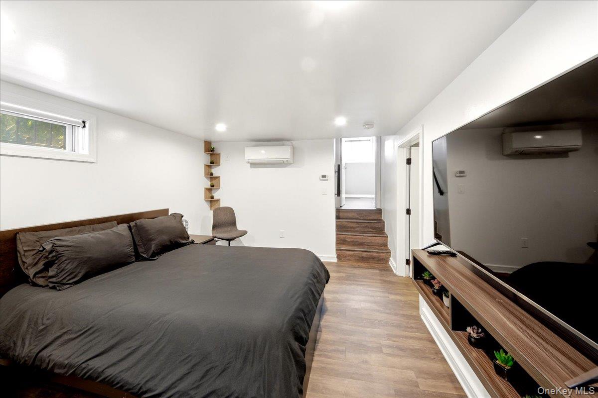 93 Fordham Street Bronx, NY 10464 - Photo 33 of 41 a bedroom with a bed and wooden floor