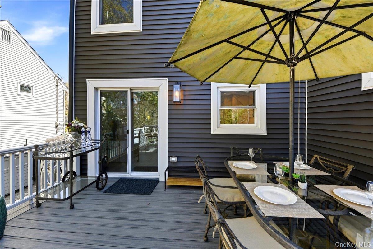 93 Fordham Street Bronx, NY 10464 - Photo 6 of 41 a view of a patio with table and chairs under an umbrella
