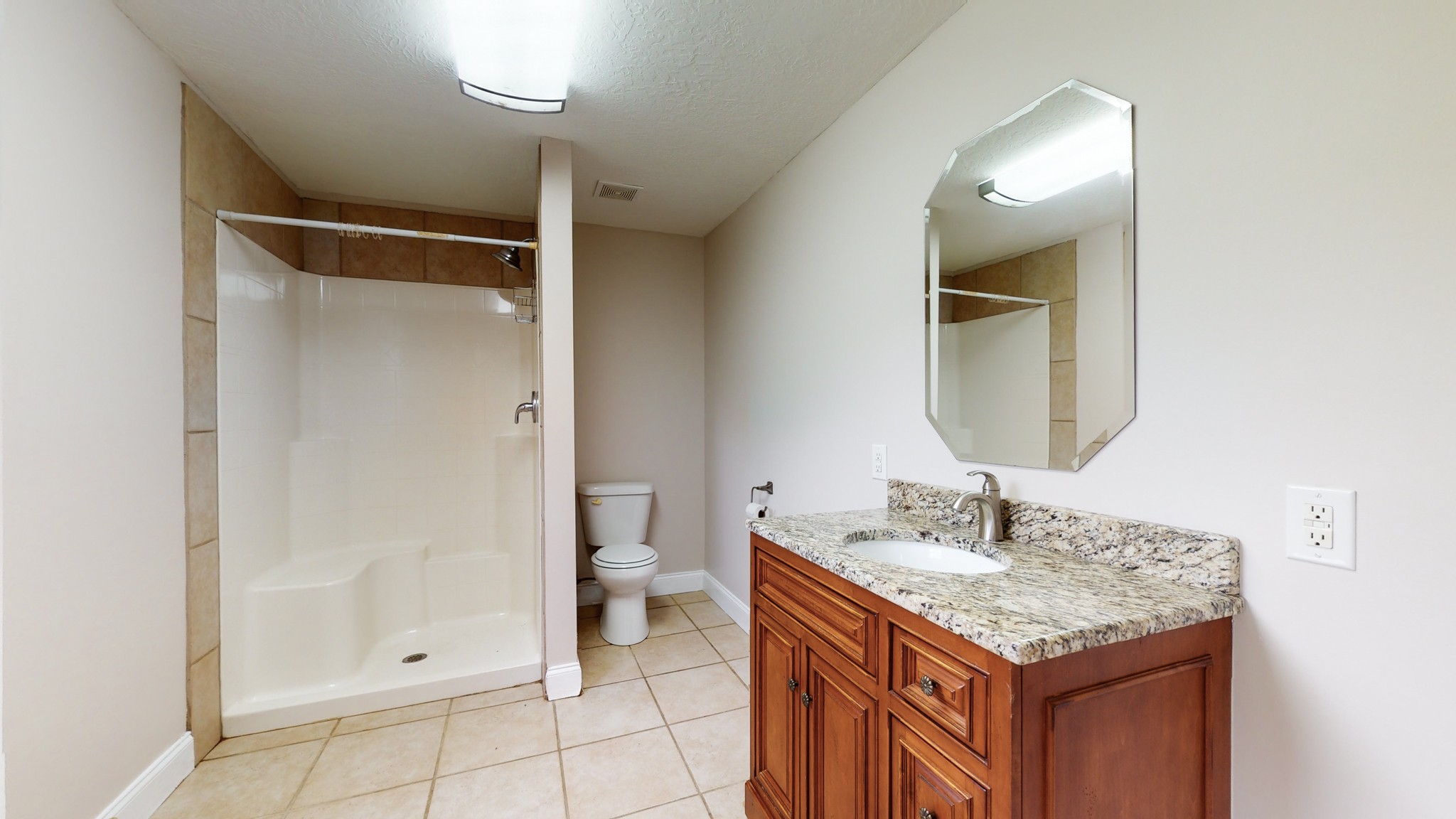 1425 India Road Paris, TN 38242 - Photo 12 of 18 a bathroom with a granite countertop sink toilet and shower