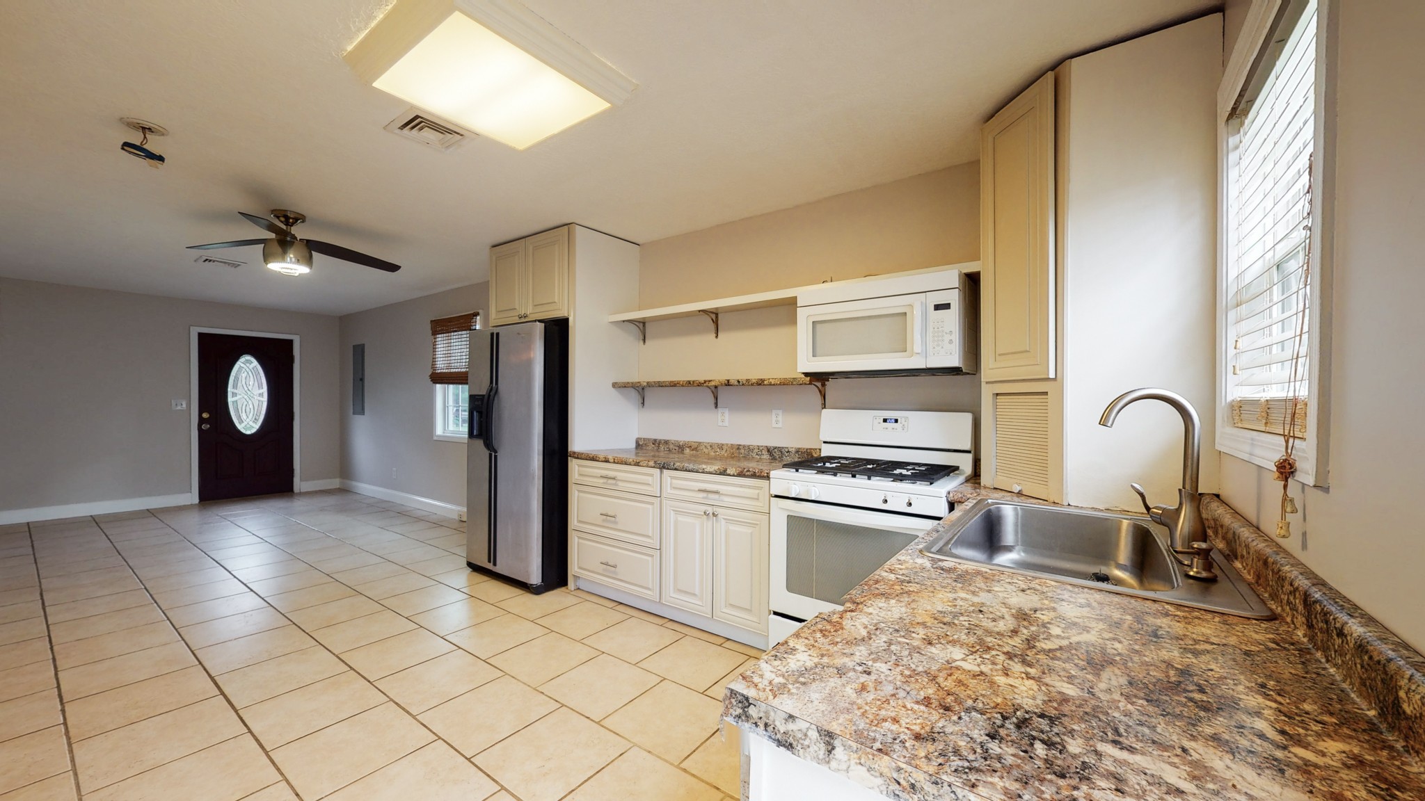 1425 India Road Paris, TN 38242 - Photo 5 of 18 a kitchen with stainless steel appliances granite countertop a stove a sink and a refrigerator