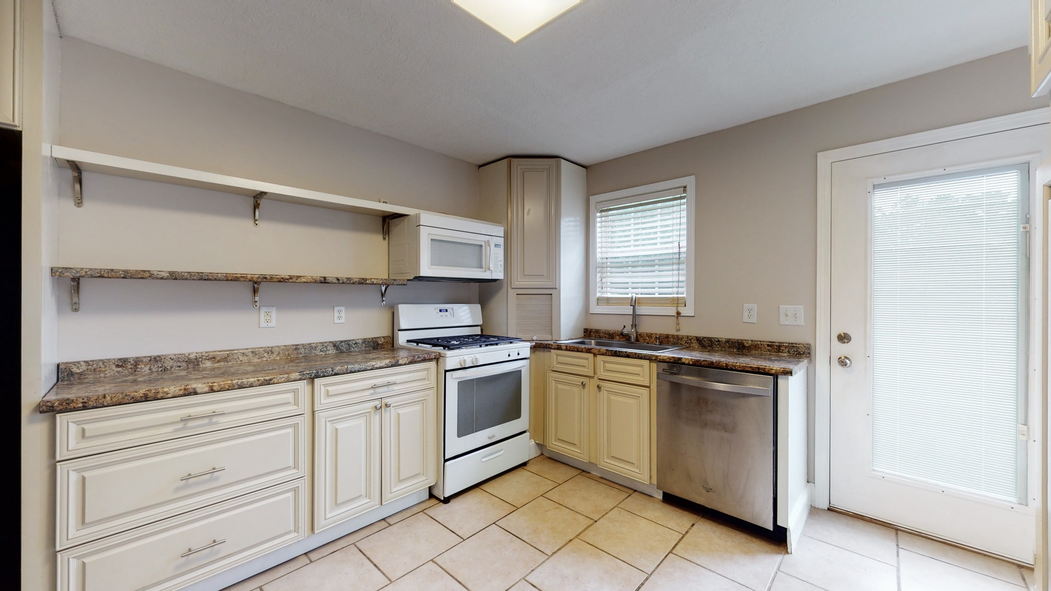 1425 India Road Paris, TN 38242 - Photo 6 of 18 a kitchen with stainless steel appliances granite countertop white cabinets and window