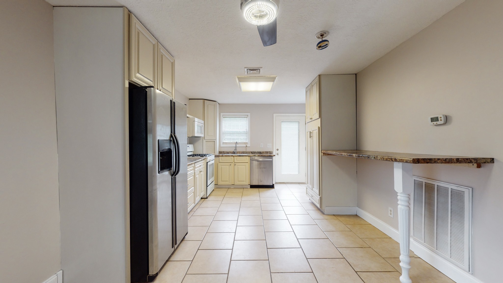 1425 India Road Paris, TN 38242 - Photo 7 of 18 a kitchen with stainless steel appliances granite countertop a refrigerator and a sink