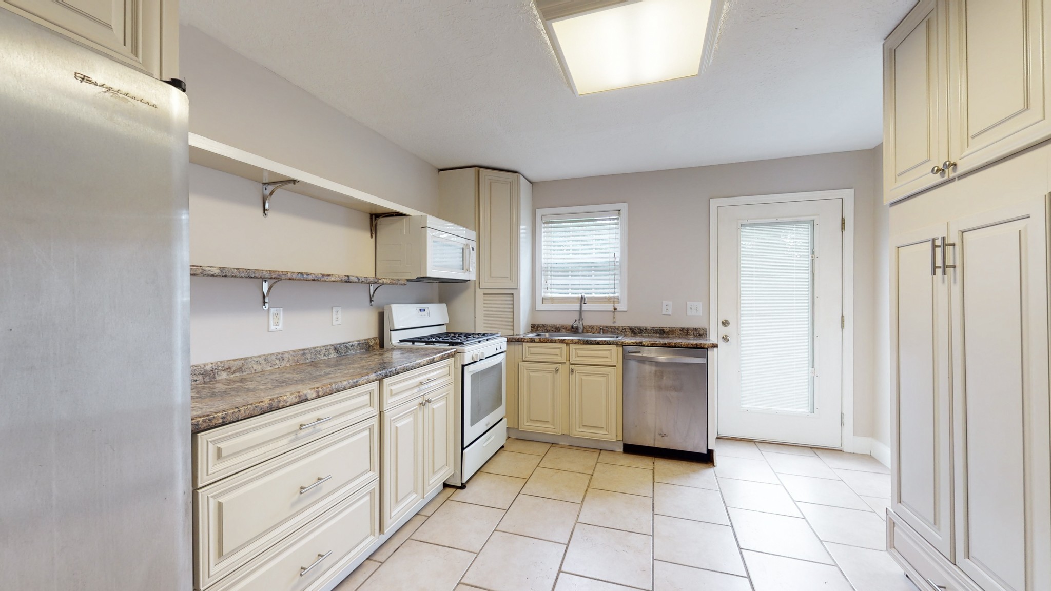 1425 India Road Paris, TN 38242 - Photo 8 of 18 a kitchen with a stove top oven sink and cabinets
