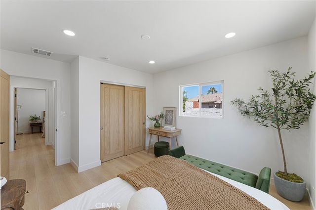 a bedroom with a bed and a couch