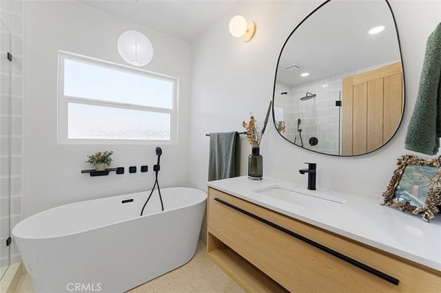 a bathroom with a bathtub and a mirror