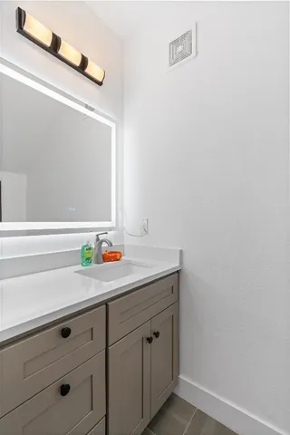 a bedroom with a bed and a mirror