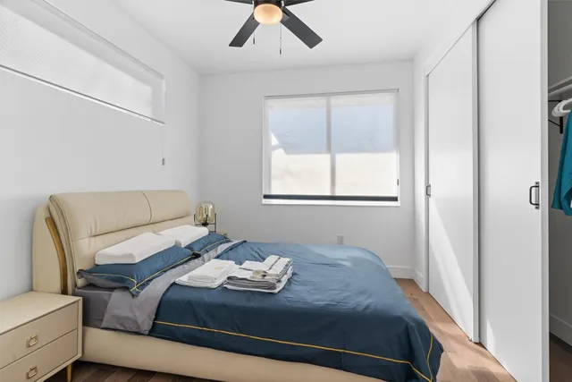 a bedroom with a bed and wooden floor