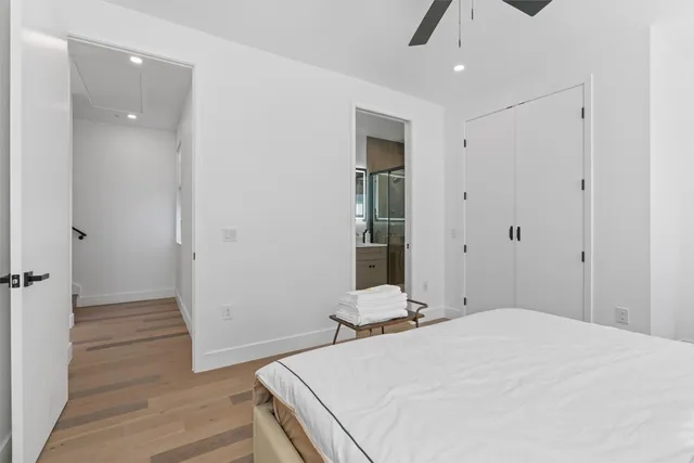 a bathroom with a toilet a sink a mirror a shower and vanity