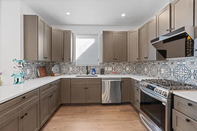 a kitchen with refrigerator and cabinets