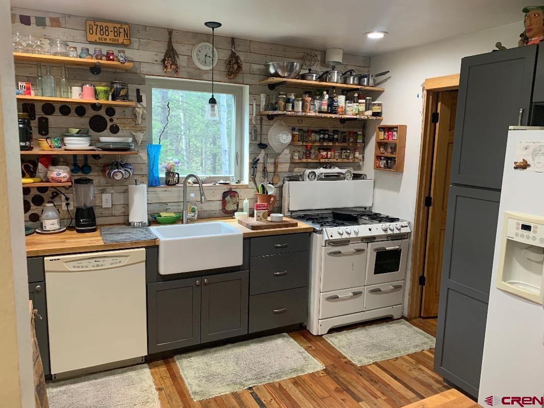 593 Crest Drive Cimarron, CO 81220 - Photo 14 of 30 a kitchen with stainless steel appliances a stove a refrigerator and a cabinets