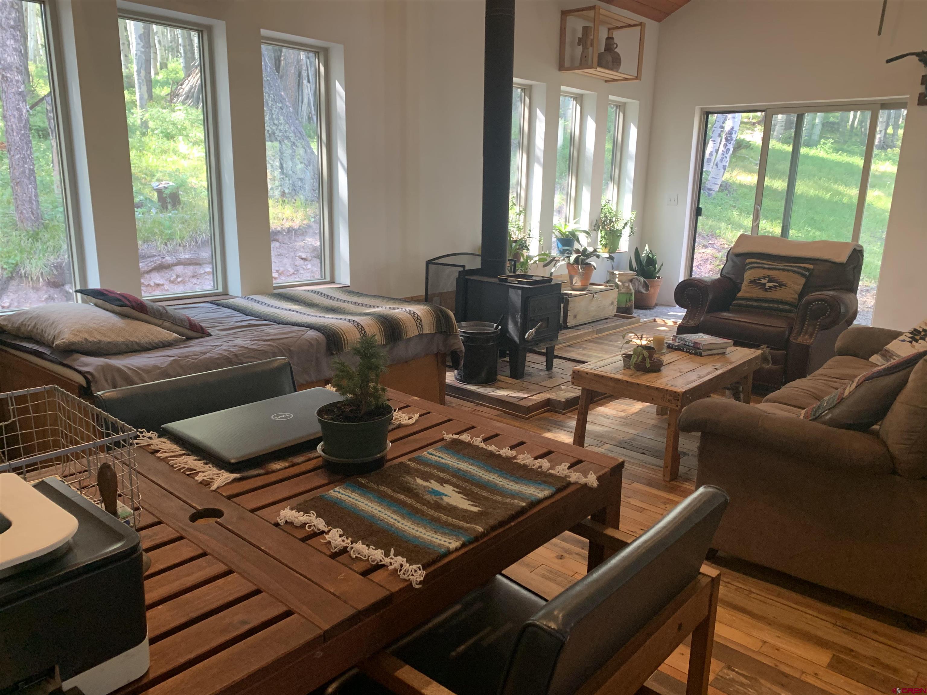593 Crest Drive Cimarron, CO 81220 - Photo 6 of 30 a bedroom with furniture and a large window
