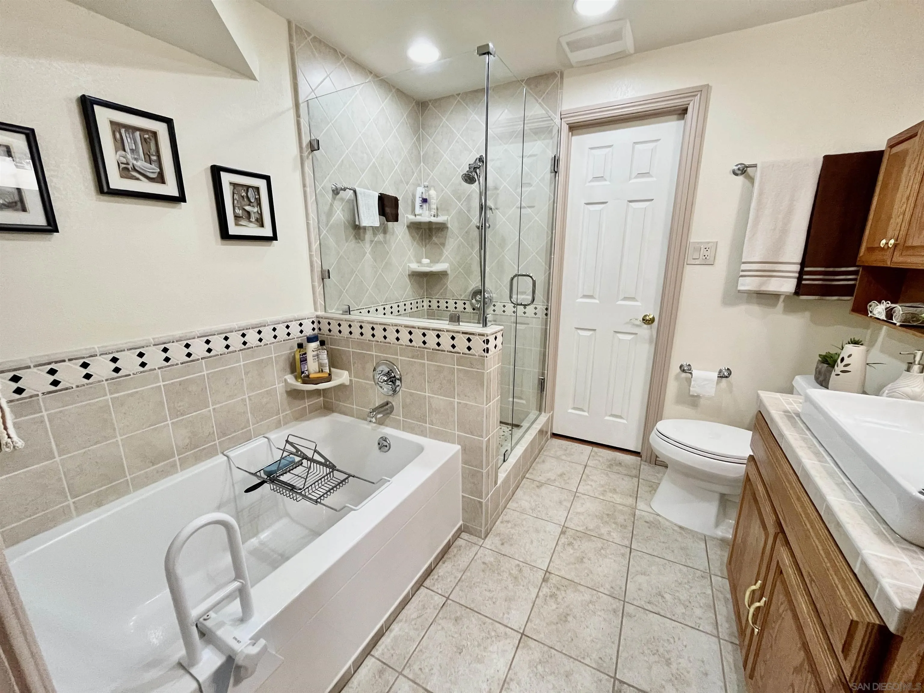 8844 Golf Drive Spring Valley, CA 91977 - Photo 21 of 56 a spacious bathroom with a tub sink and mirror