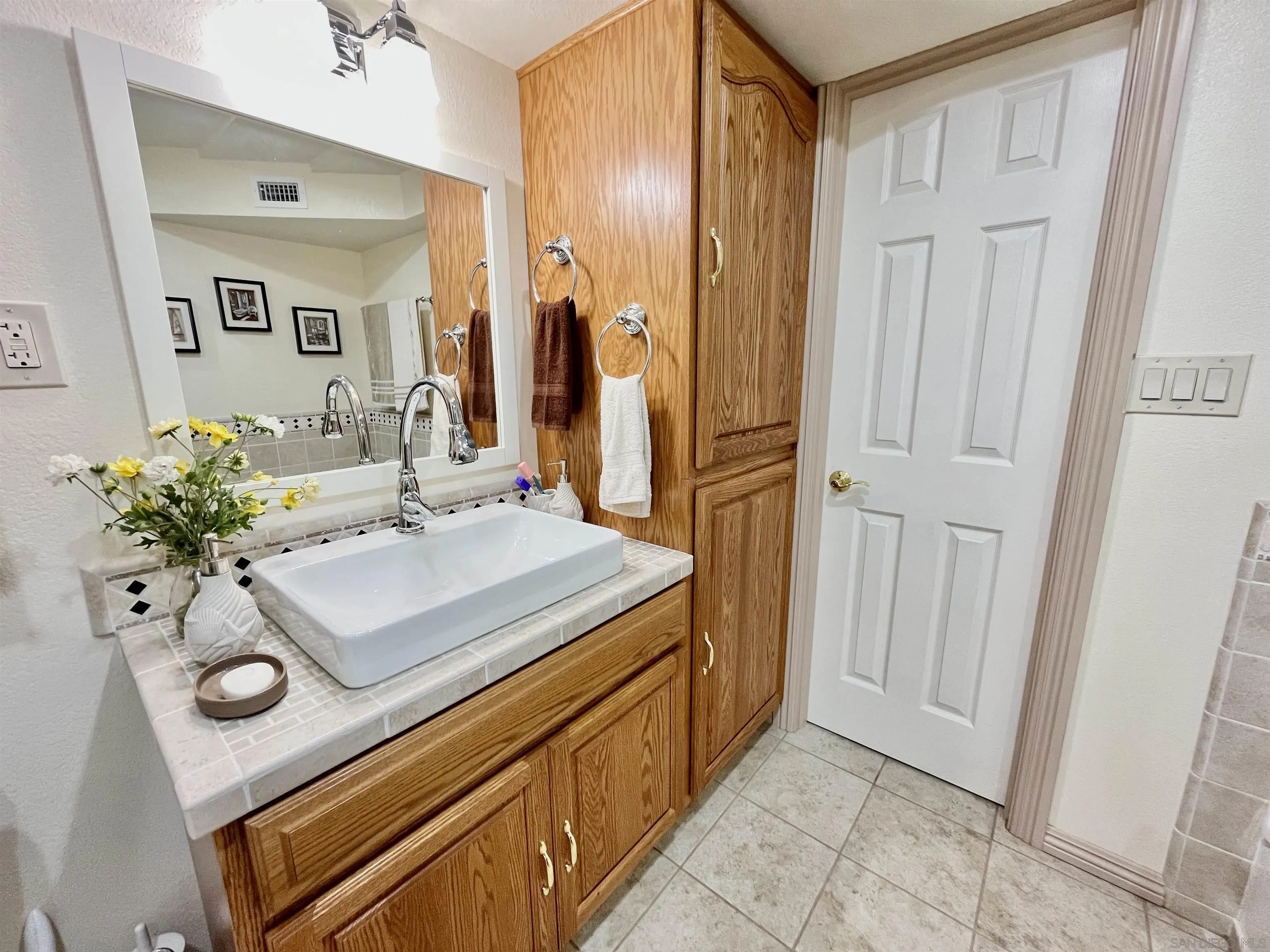 8844 Golf Drive Spring Valley, CA 91977 - Photo 22 of 56 a bathroom with a sink vanity and a mirror