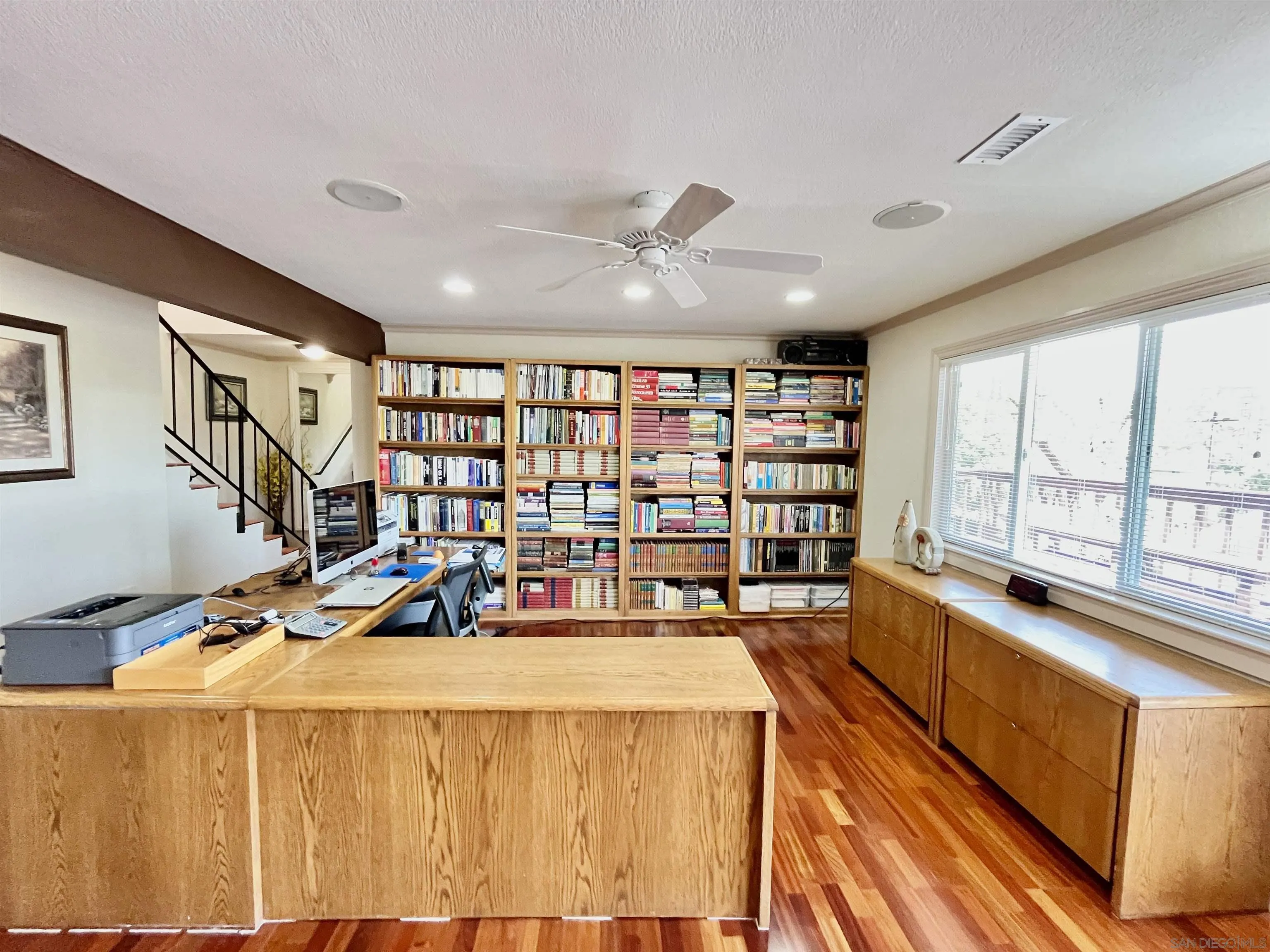 8844 Golf Drive Spring Valley, CA 91977 - Photo 34 of 56 a living room with furniture a large window and bookshelf