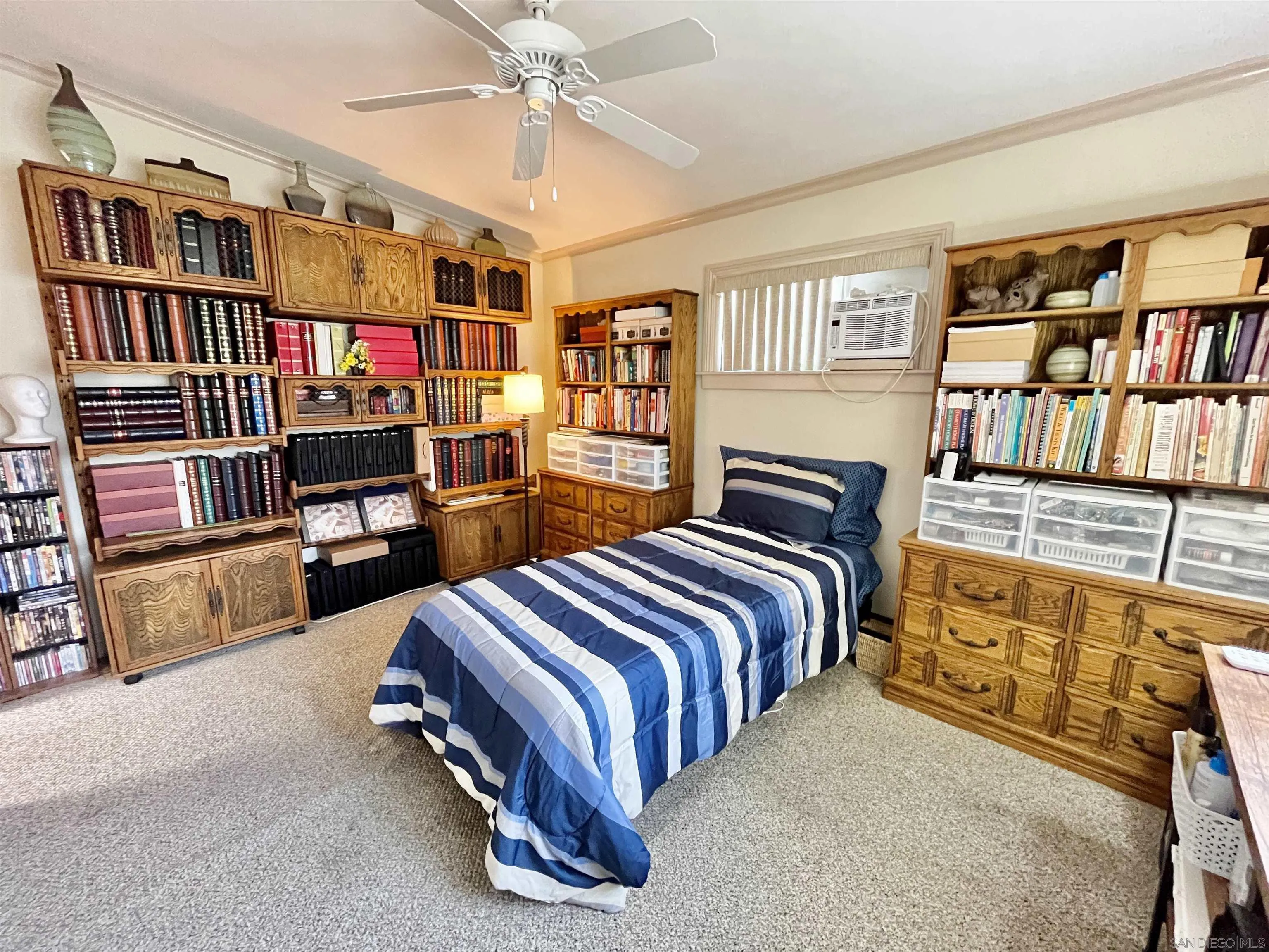 8844 Golf Drive Spring Valley, CA 91977 - Photo 39 of 56 a bedroom with a bed furniture and a book shelf