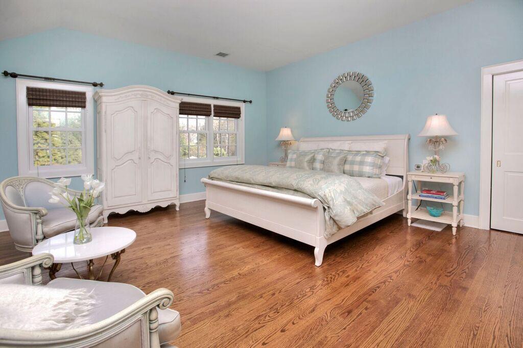 45 Ridge Acres Road Darien, CT 06820 - Photo 15 of 25 a bedroom with a bed and wooden floor