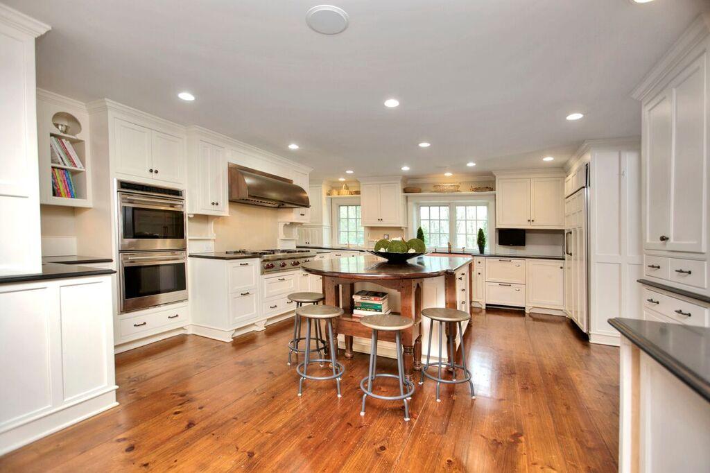 45 Ridge Acres Road Darien, CT 06820 - Photo 6 of 25 a kitchen with stainless steel appliances kitchen island wooden floors and refrigerator