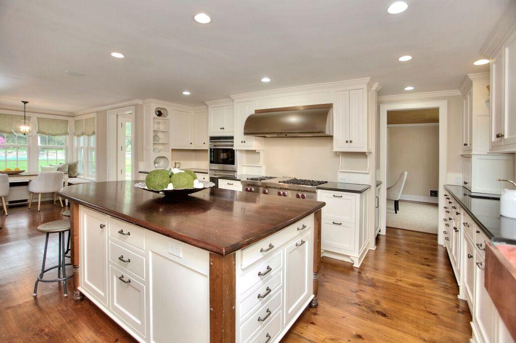45 Ridge Acres Road Darien, CT 06820 - Photo 7 of 25 a kitchen with stainless steel appliances kitchen island granite countertop a sink and a stove top oven