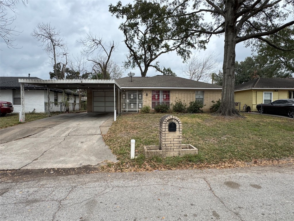 3007 Trenton Road Houston, TX 77093 - Photo 1 of 12 a front view of a house with a yard and garage