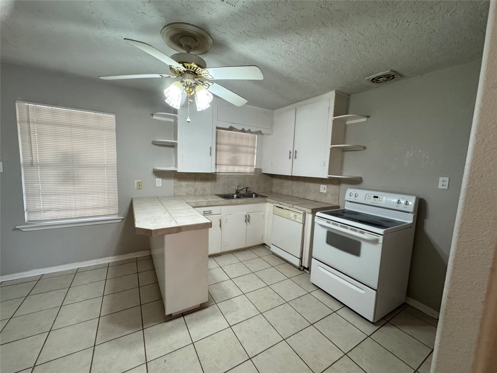 3007 Trenton Road Houston, TX 77093 - Photo 6 of 12 a kitchen with a stove cabinets and window