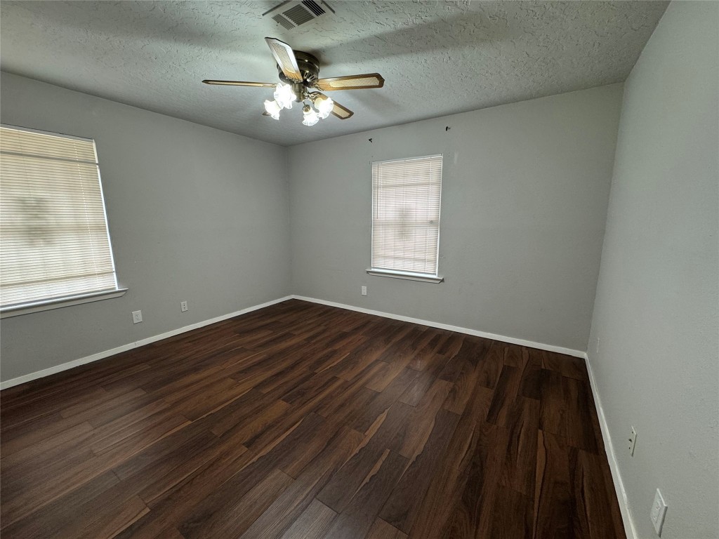 3007 Trenton Road Houston, TX 77093 - Photo 8 of 12 a view of an empty room with wooden floor and a window