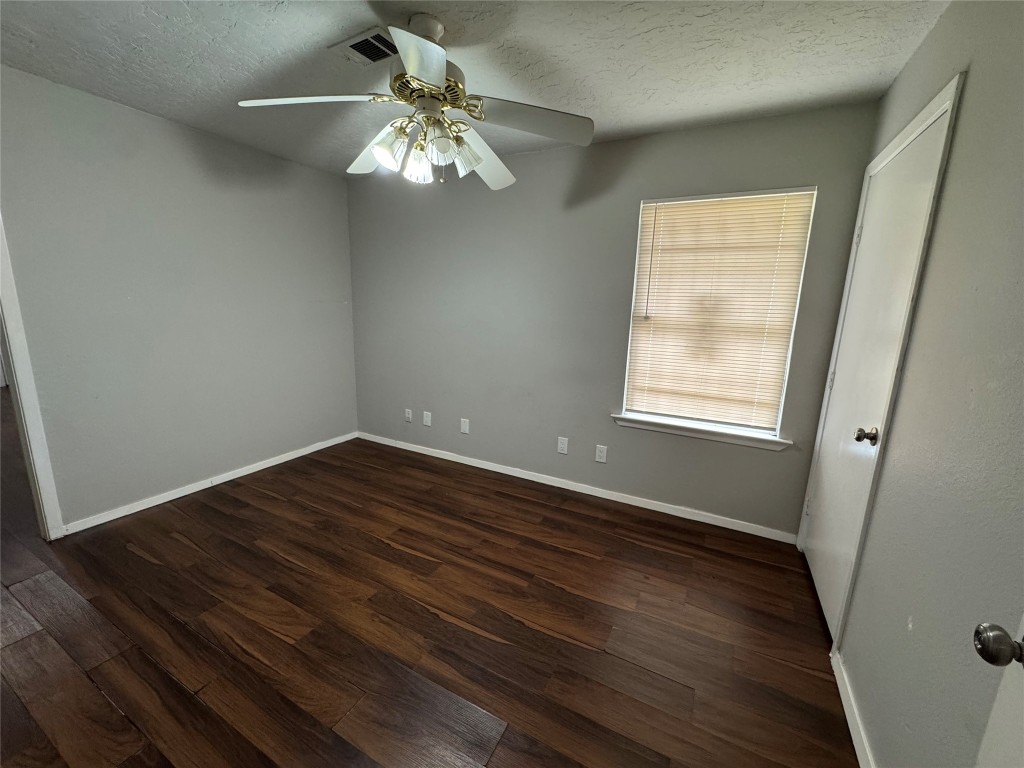 3007 Trenton Road Houston, TX 77093 - Photo 9 of 12 a view of an empty room with wooden floor and a window