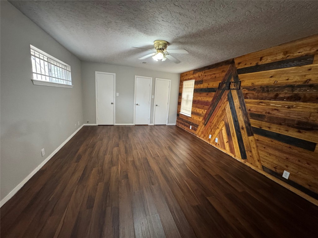 3007 Trenton Road Houston, TX 77093 - Photo 10 of 12 a view of an empty room with wooden floor and a ceiling fan