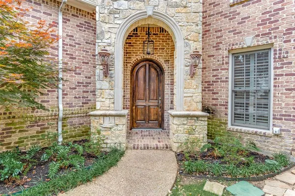 a view of a brick house with a large windows