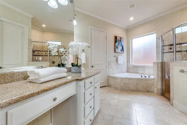 a spacious bathroom with a granite countertop tub sink and mirror