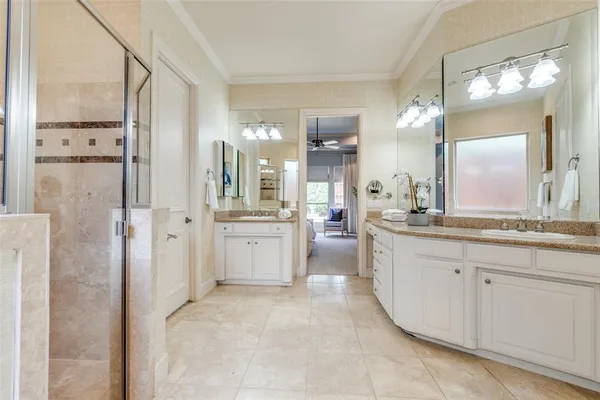 a large bathroom with a double vanity sink mirror and shower